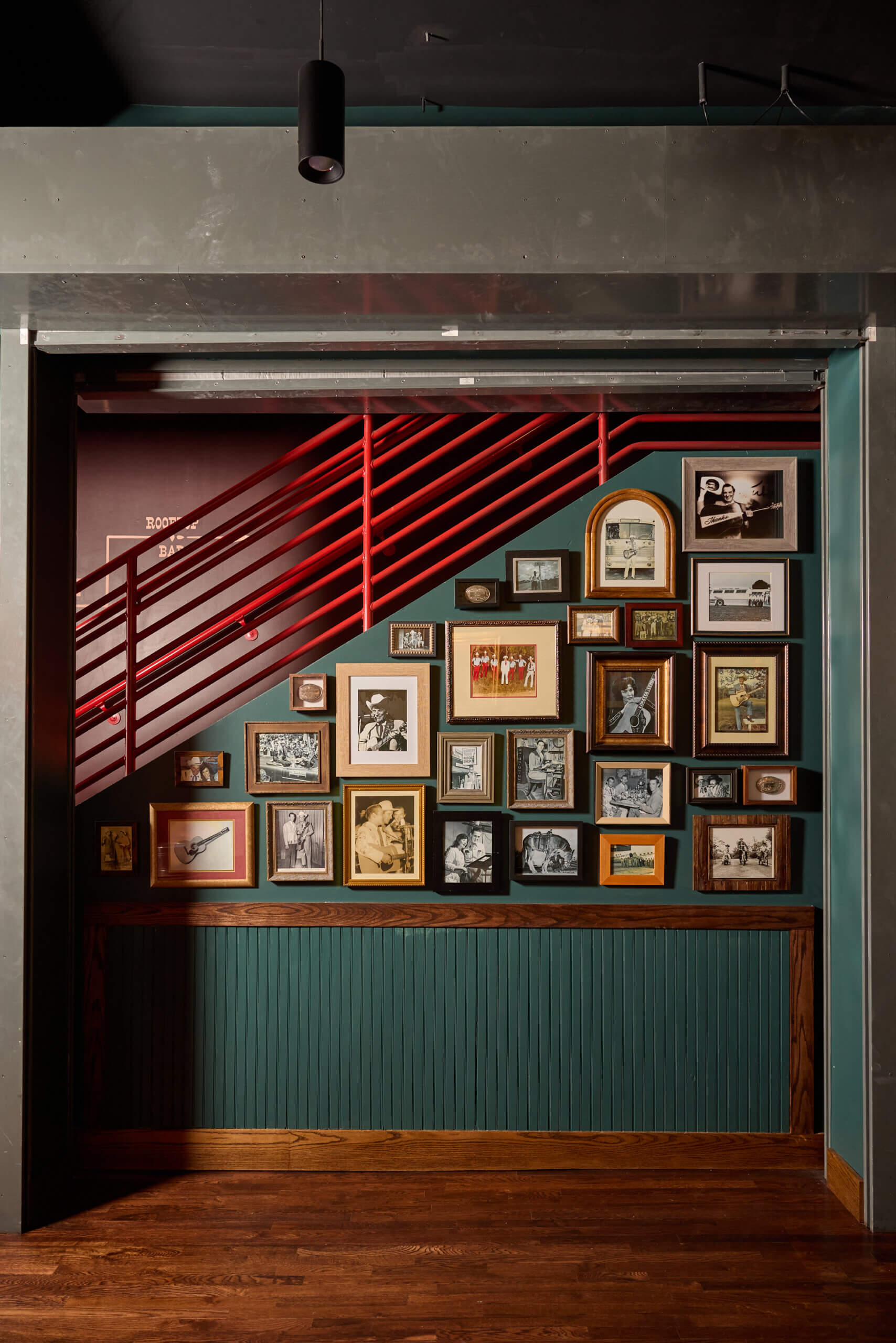 Framed photos and memorabilia displayed on historic interior walls
