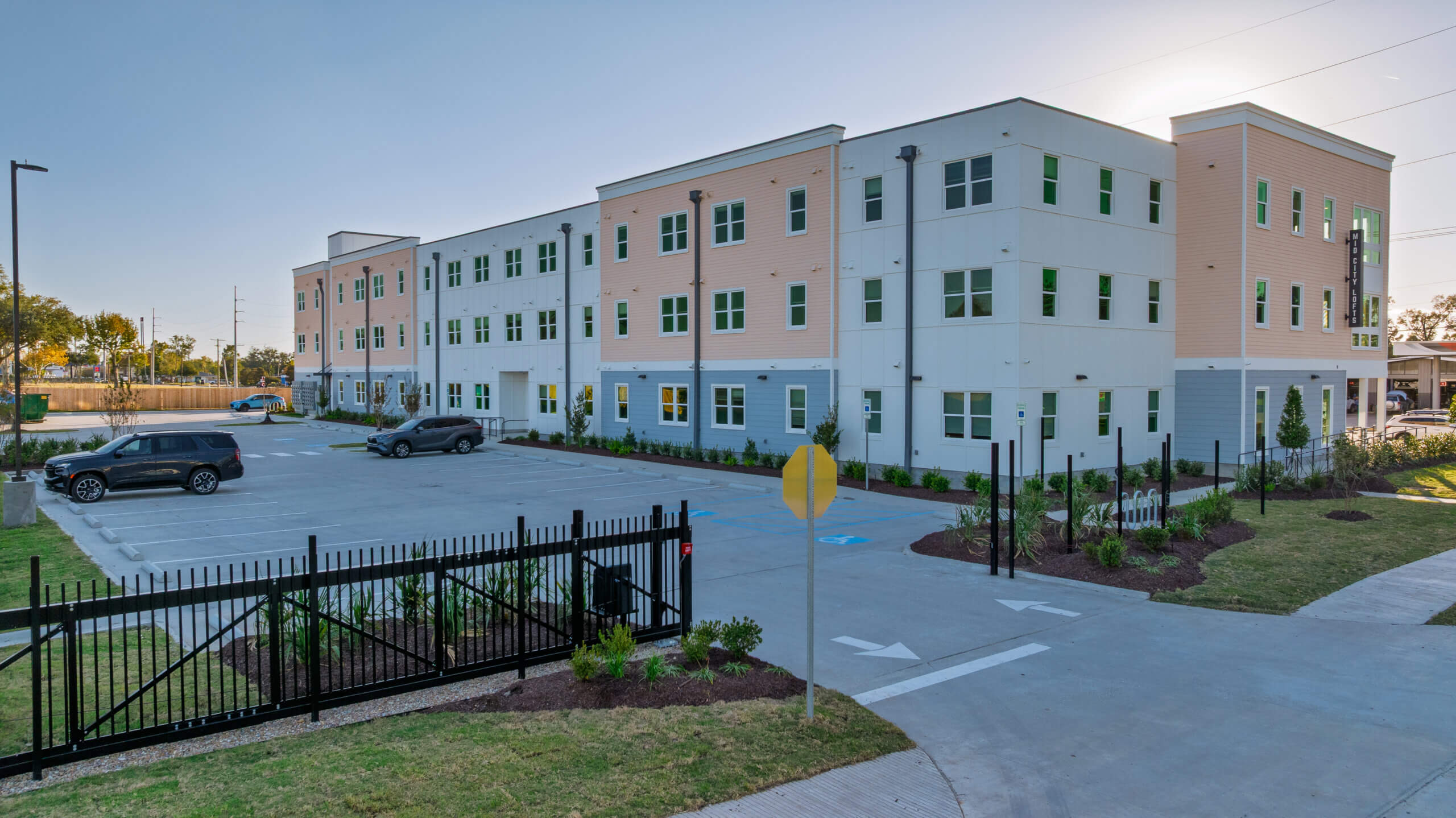Aerial view of Mid City Lofts showing parking, site layout, and surrounding neighborhood in Lake Charles