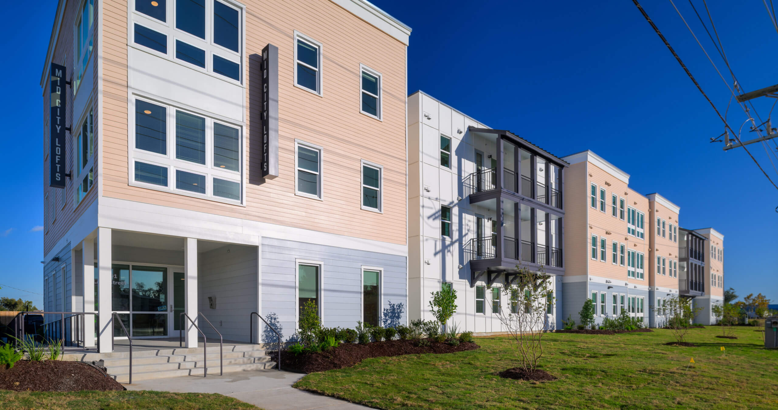 Exterior view of the completed Mid City Lofts mixed-income residential building in Lake Charles, Louisiana