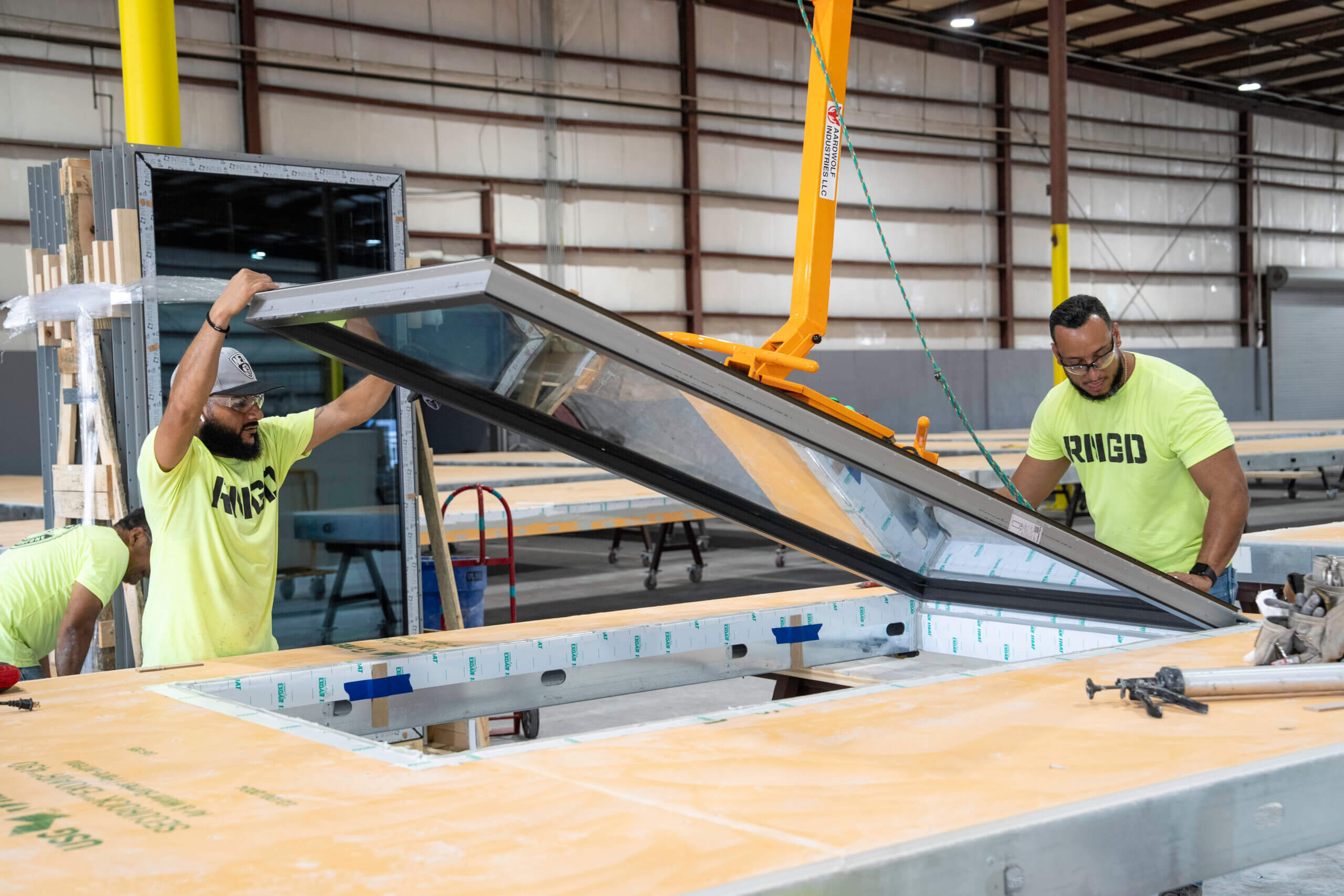 RNGD team assembling prefabricated exterior wall panel in manufacturing facility