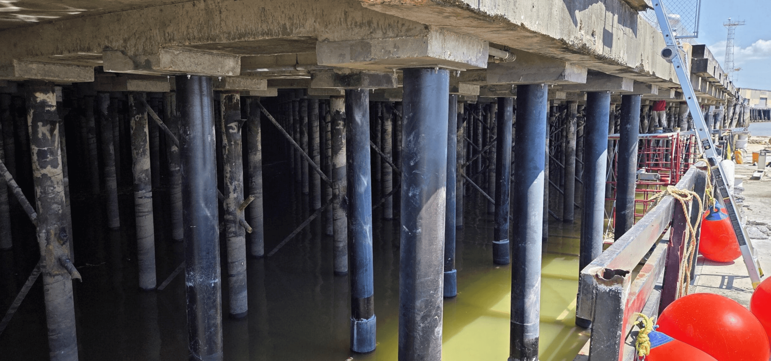 New sleeved pile assemblies installed beneath Governor Nichols Wharf restoring structural capacity to the dock.