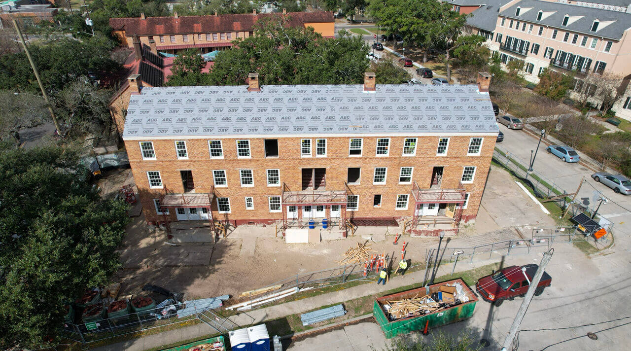Elevated view of historic Lafitte building with newly installed roof and ongoing exterior restoration