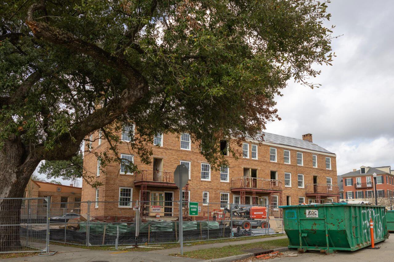 Historic Lafitte building undergoing renovation with masonry repairs and construction equipment on site