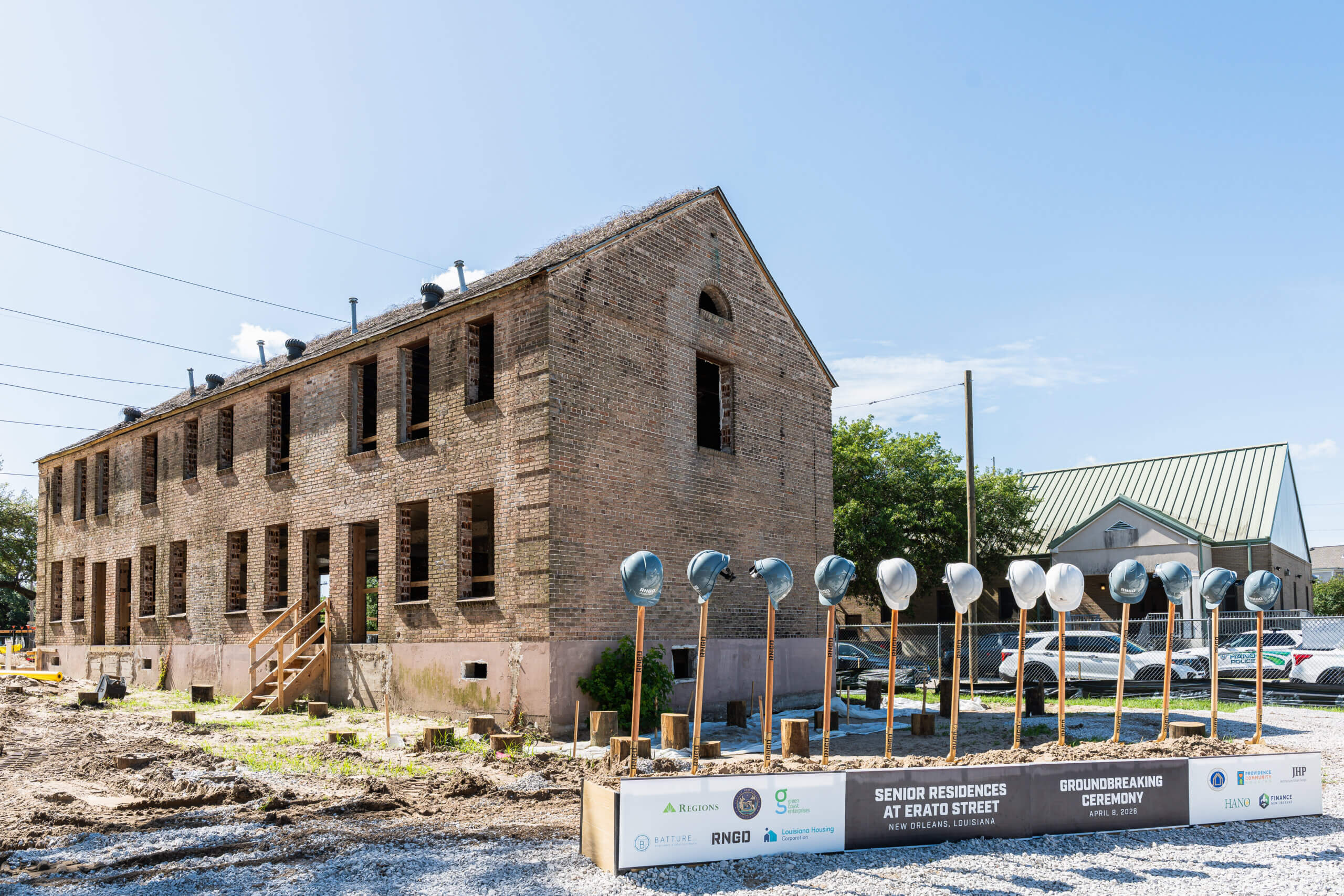 Historic BW Cooper building with ceremonial shovels prepared for groundbreaking event