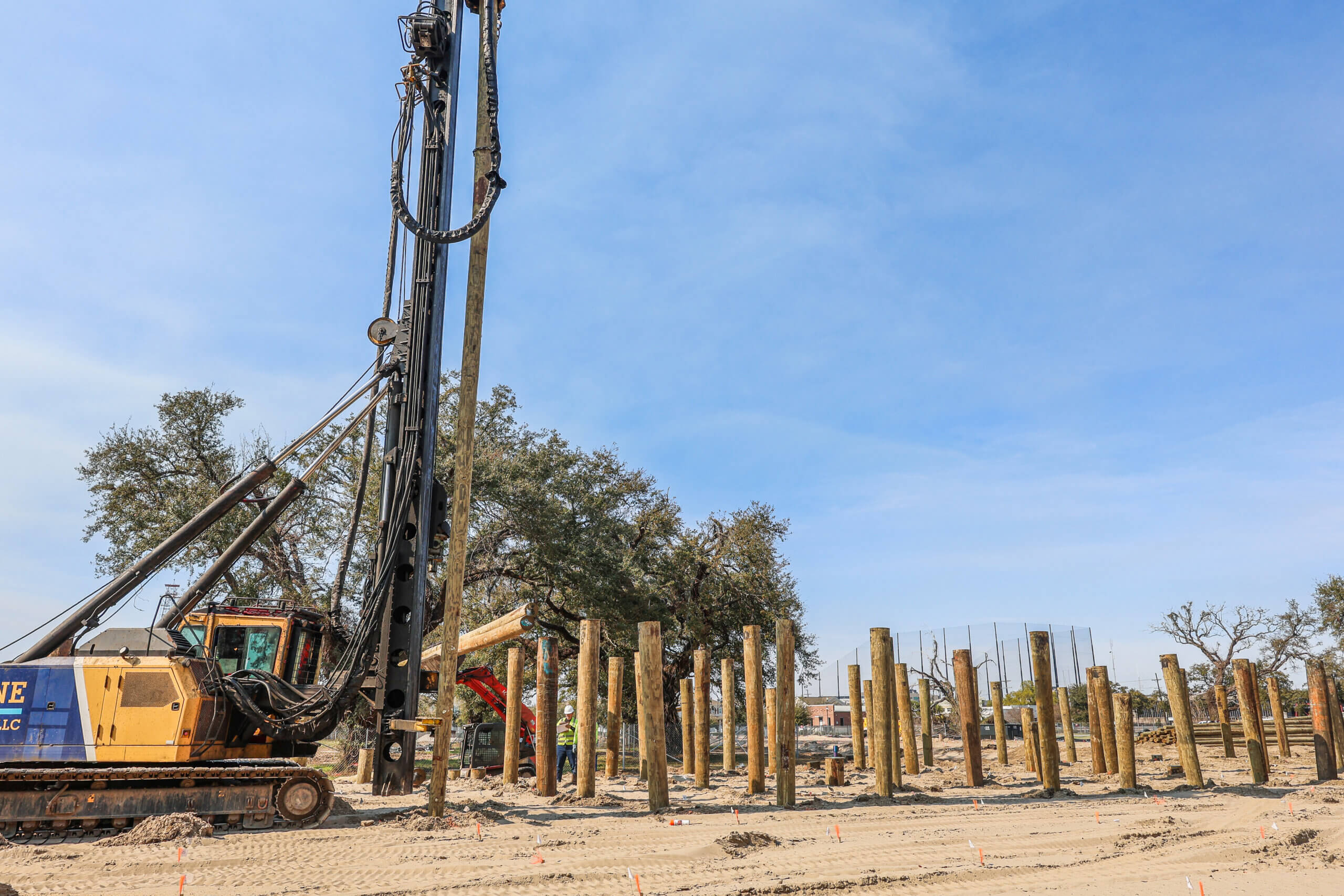 Pile driving equipment installing timber piles at BW Cooper Senior Residences construction site